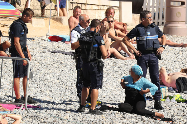 Exclusive... 52154061 Police fine the first person for wearing a burkini on the Promenade des Anglais beach in Nice, France on August 23, 2016. The cops made the woman remove her clothing in front of fellow beach goers following the recent burkini ban. **NO USE W/O PRIOR AGREEMENT - CALL FOR PRICING** FameFlynet, Inc - Beverly Hills, CA, USA - +1 (310) 505-9876 RESTRICTIONS APPLY: USA ONLY
